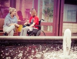disabled guest in wheelchair and carer at Jubilee Lodge during Youth Week