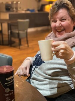 Revitalise resident Toni-Marie enjoying coffee