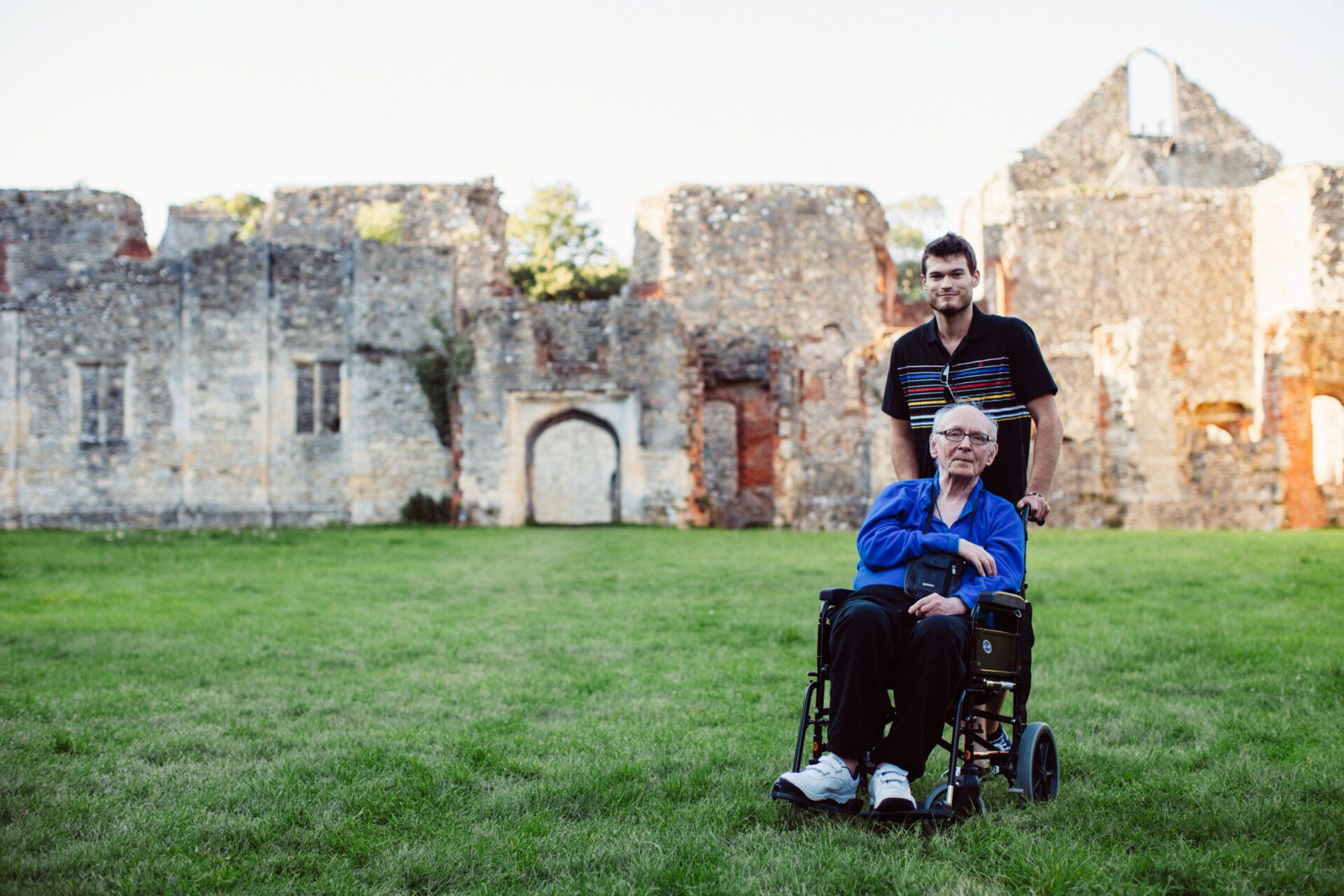 Revitalise wheelchair using guest and volunteer on an excursion outside old building