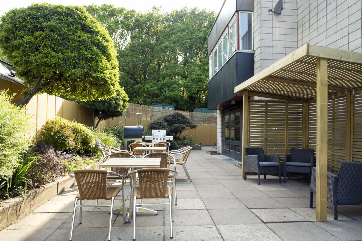 Exterior view of patio tables at Revitalise Jubilee Lodge