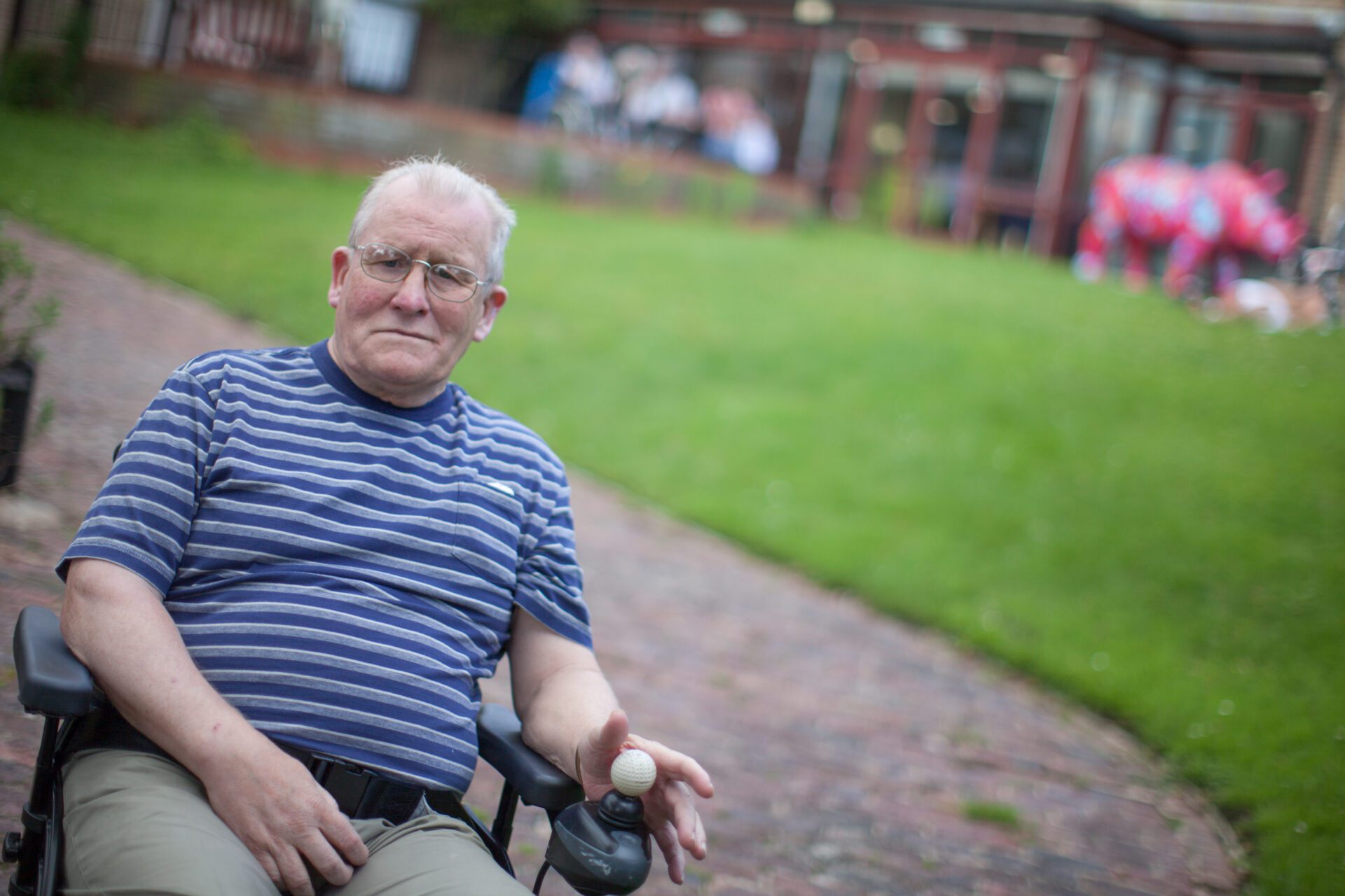 Man in wheelchair outside of Revitalise Netley Waterside House