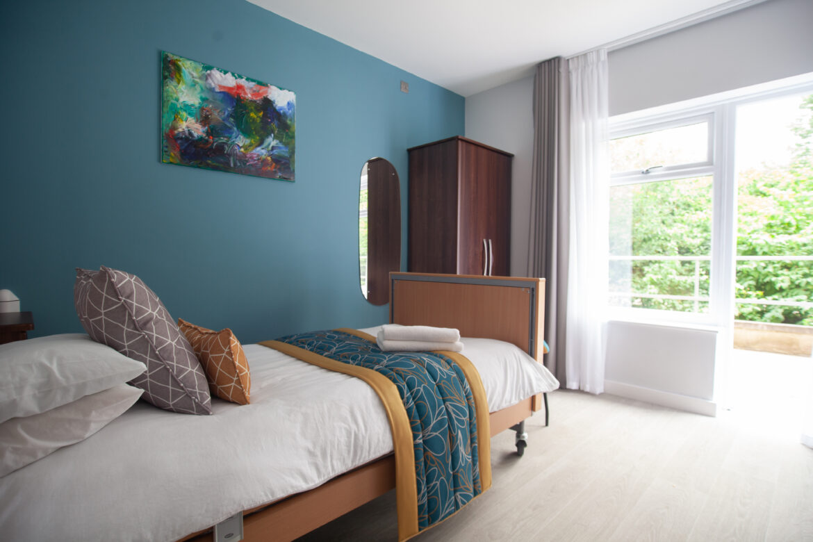 Revitalise Jubilee Lodge bedroom with shades of teal and gold following a refurbishment with fully accessible furniture