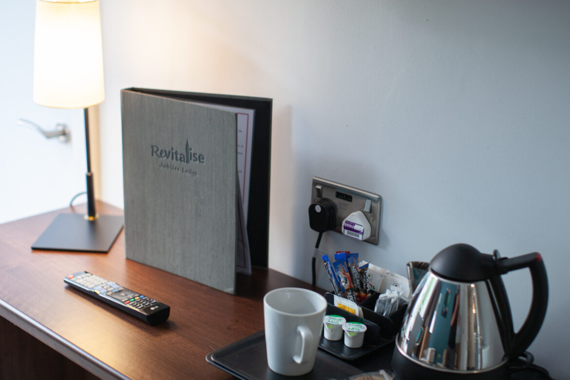 Desk details including information book and tea and coffee making station in Jubilee Lodge bedroom