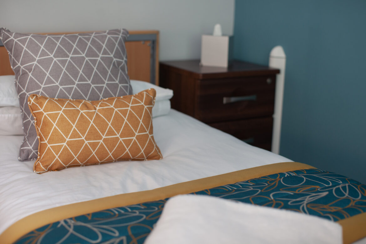 Detail shot of new soft furnishings in shades of grey, gold and teal in guest bedrooms at Jubilee Lodge