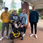 Revitalise guest Luke Murphy at Sandpipers with three volunteers