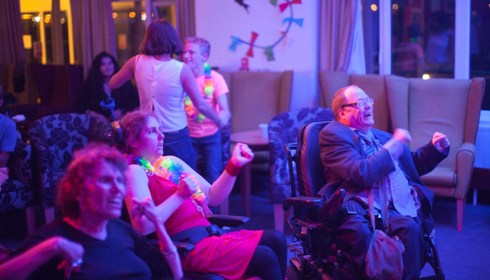 Disabled people dancing during live entertainment night at Revitalise Sandpipers