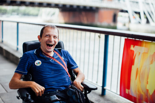 Man in wheelchair enjoying an excursion in London on a day trip from Revitalise Jubilee Lodge