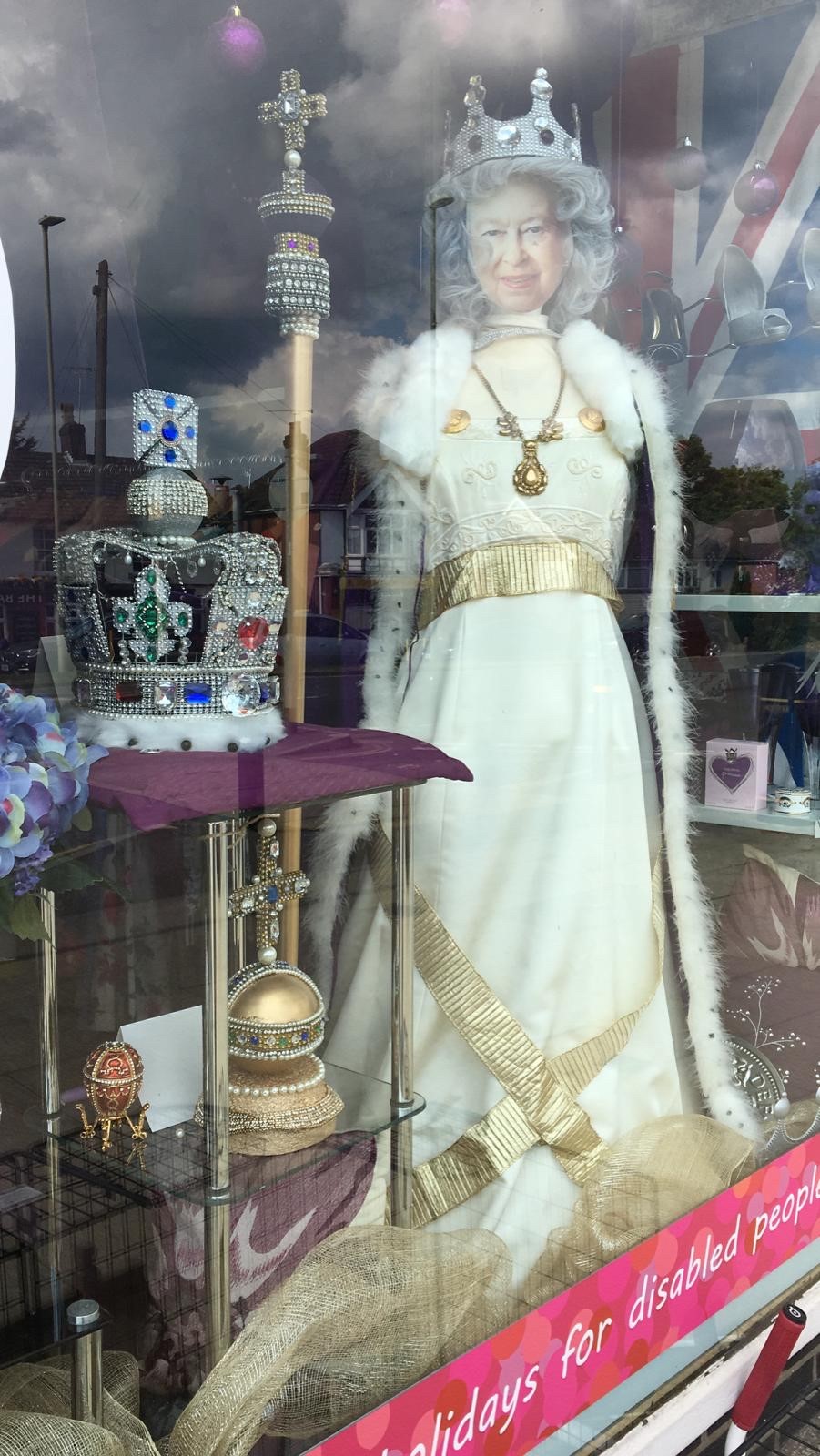 Window display of Revitalise charity shop at Hedge End displaying Platinum Jubilee related clothes and accessories