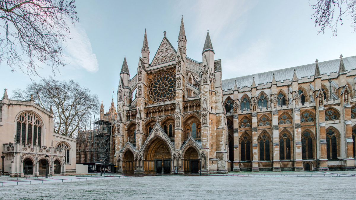 Image of Westminster Abbey and its grounds covered in snow, showcasing its stunning Gothic architecture.