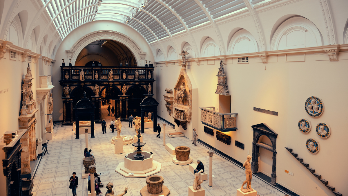 Image of one of the exhibition halls of the Victoria and Albert Museum. The exhibit is showcasing various artifacts and sculptures.