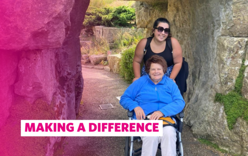 Image of our guest and a volunteer on a day trip to the Kew Garden. They are smiling at the camera and the guest is using a wheelchair. There's a pink overlay on the image with the text: Making a Difference