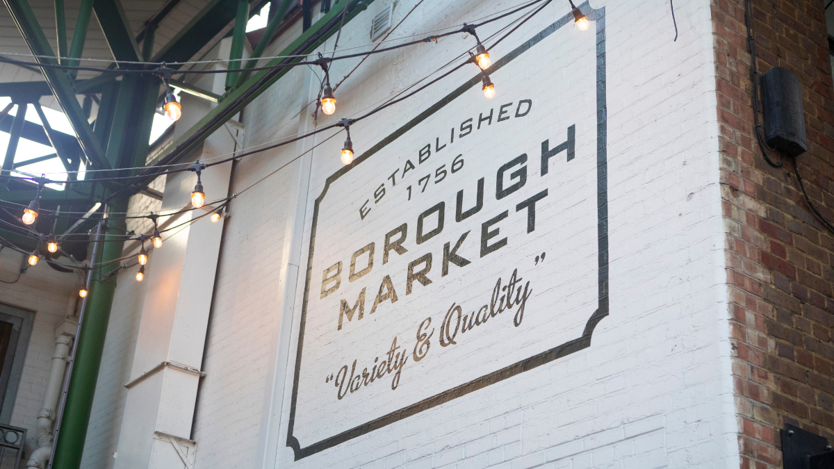 Image shows a white wall with a large painted sign that reads: established 1756 Borough Market variety and quality.